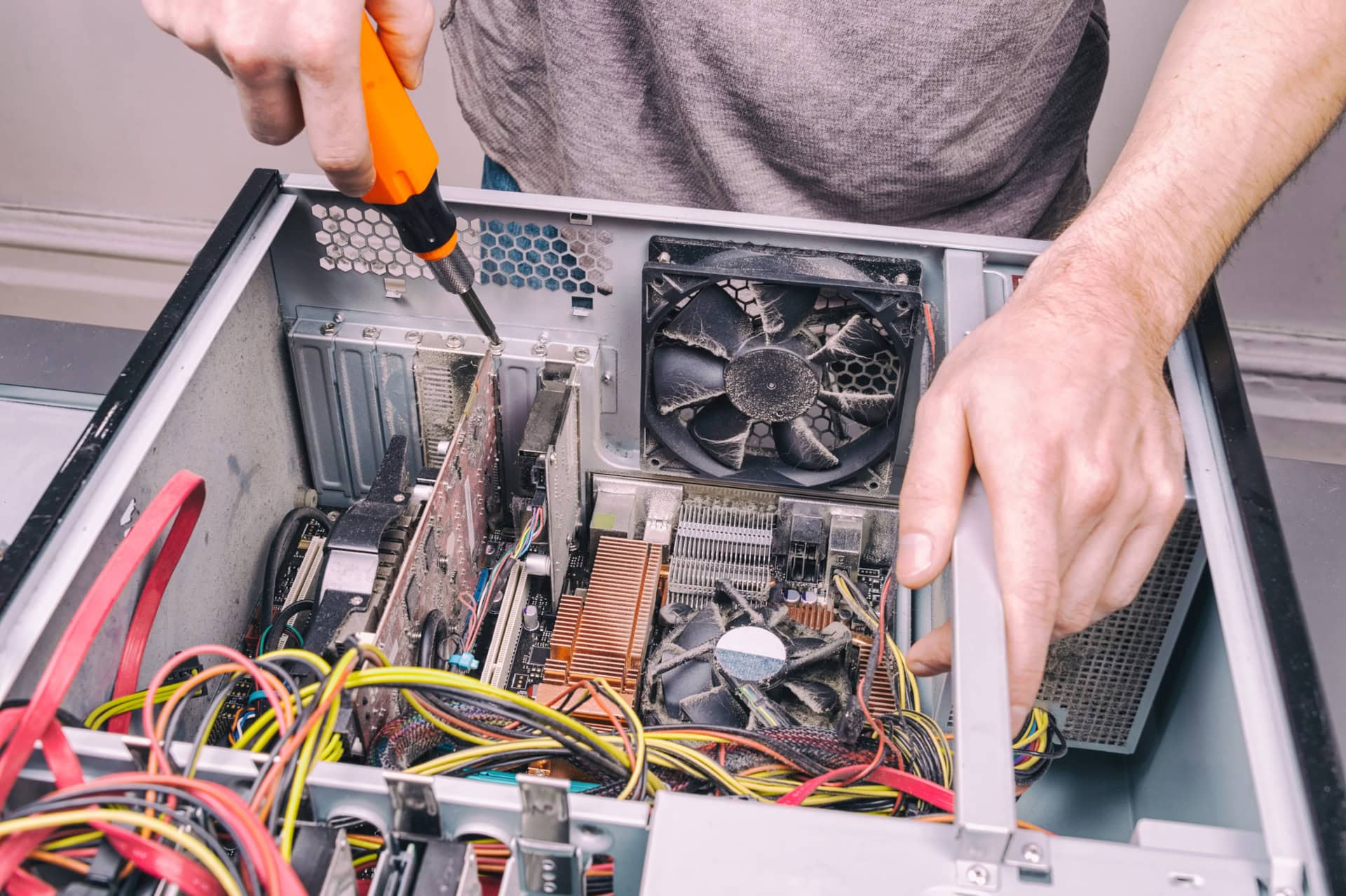 Technician performing desktop computer hardware repair and maintenance